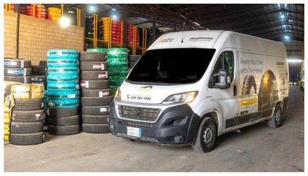 A shot of the Estbnh mobile installation VAN next to a set of new tires destined to customers